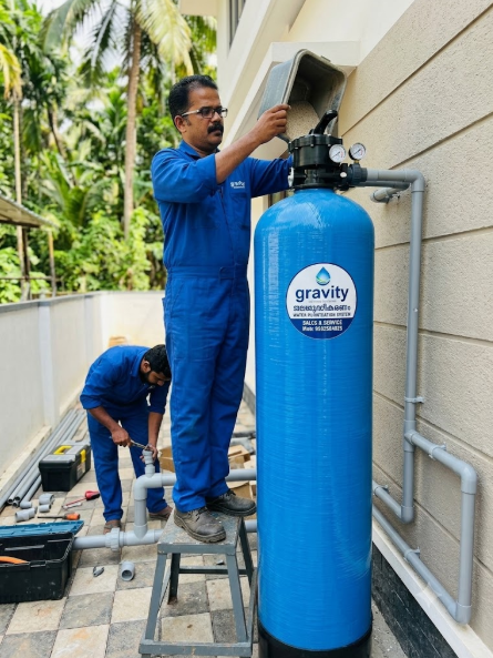 Gravity Water Treatment engineers installing whole house FRP filtration vessel on site in Vadakkencherry, Palakkad